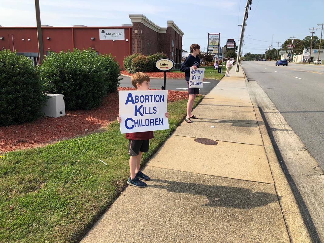 GREENSBORO — Parishioners of Our Lady of Grace Parish held signs as silent witnesses and prayed on behalf of the unborn at a Life Chain in Greensboro.  The life chain was held along one of Greensboro’s busiest streets, Battleground Avenue.  (Provided by N