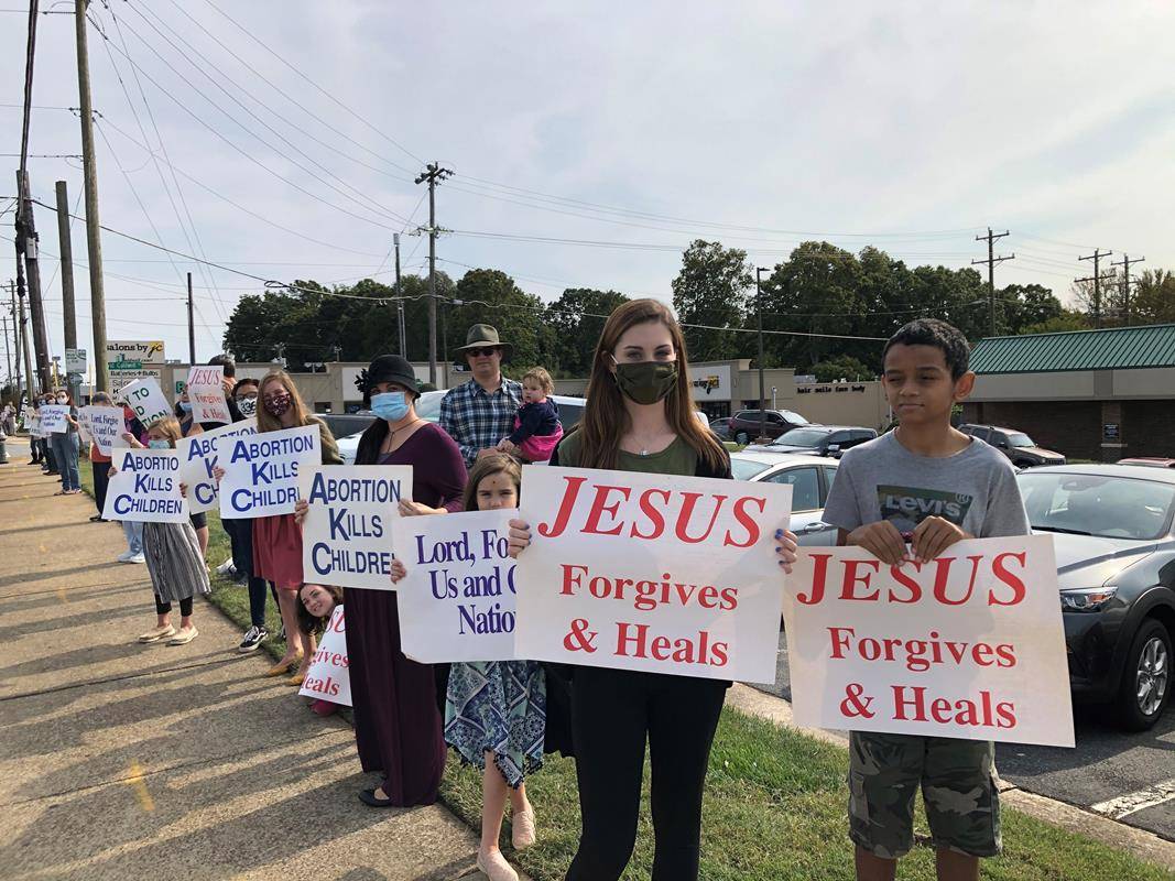 GREENSBORO — Parishioners of Our Lady of Grace Parish held signs as silent witnesses and prayed on behalf of the unborn at a Life Chain in Greensboro.  The life chain was held along one of Greensboro’s busiest streets, Battleground Avenue.  (Provided by N